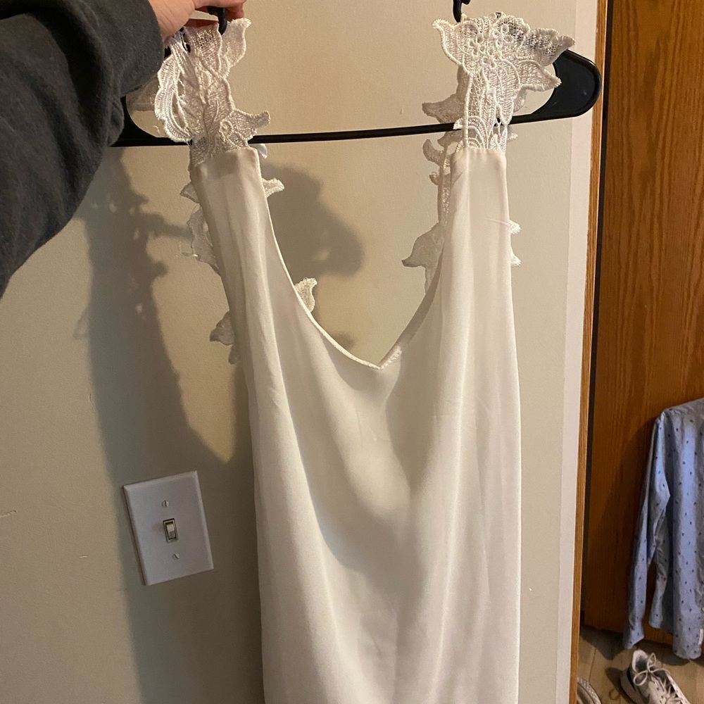Backless white dress with lace straps.